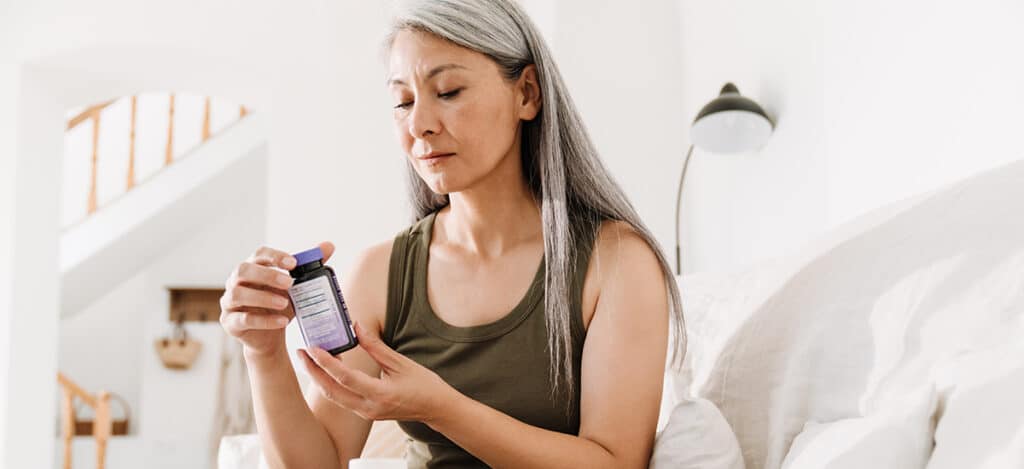 Mature woman reading the prescription on her medication