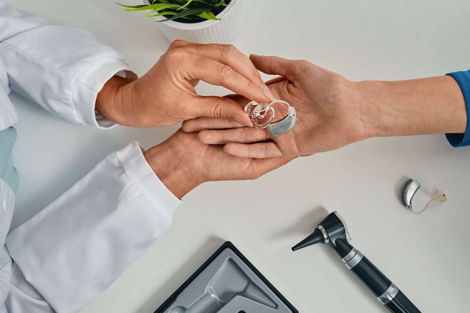 audiologist holding hearing aid